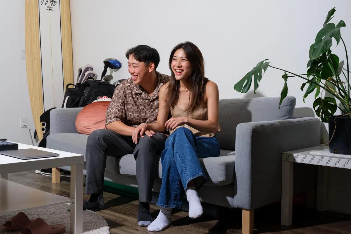 Colin Li and Caroline Wang at the apartment they share with a third renter, near Santa Monica, Calif., June 27, 2024. Faced with a low inventory of affordable housing and steep competition among buyers and renters, many young couples are moving in together early in their relationships to save money on housing and living costs. (Tag Christof/The New York Times)