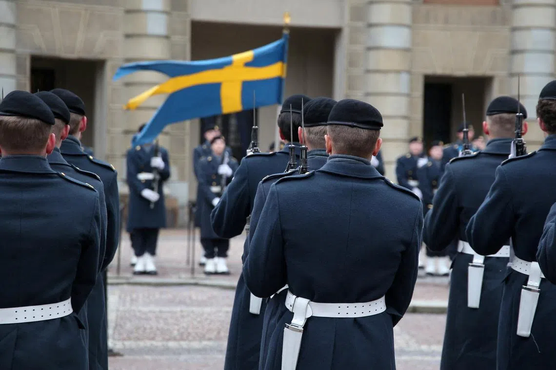 FILE PHOTO: Swedish soldiers take part in the changing of the guard ceremony in the courtyard of the Royal Palace in Stockholm, Sweden, February 24, 2024. REUTERS/Tom Little/File Photo