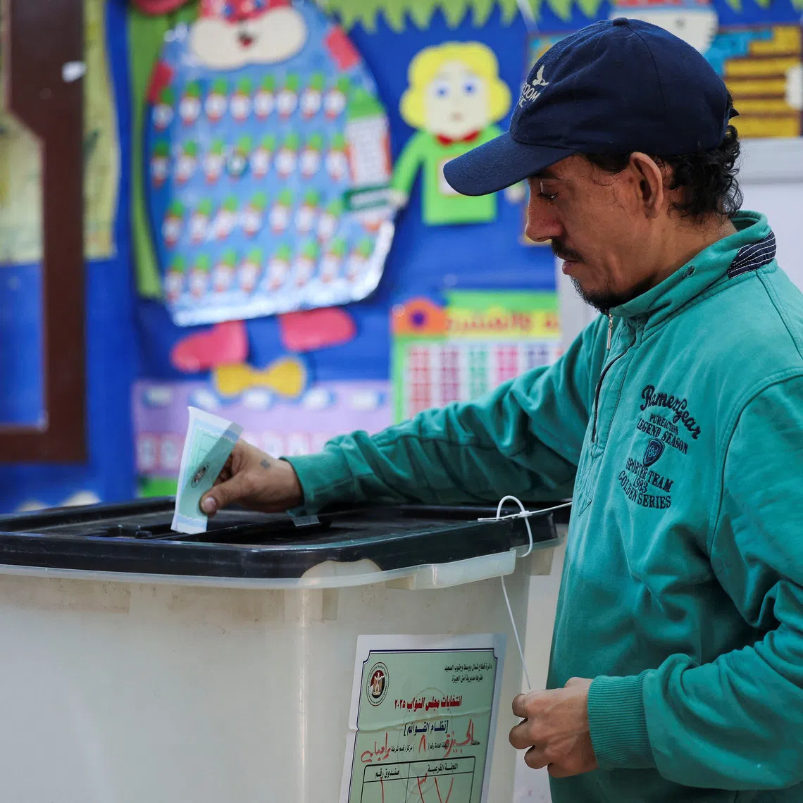 A man votes at a school used as a polling station, during the first round of Egypt's parliamentary elections, in Giza, Egypt, November 10, 2025. REUTERS/Mohamed Abd El Ghany