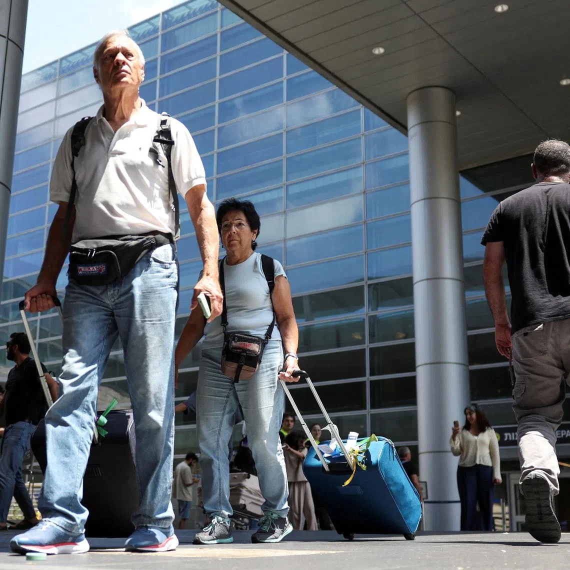 Israeli nationals walk at Ben Gurion International airport as they arrive on the first rescue flight from abroad, after U.S. President Donald Trump announced a ceasefire between Israel and Iran, in Tel Aviv, Israel, June 24, 2025. REUTERS/Violeta Santos Moura
