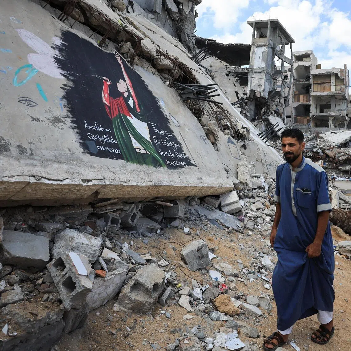 A Palestinian walks past a mural painted in honour of American rapper Macklemore, amid buildings destroyed during the war, in Gaza City, September 18, 2026. REUTERS/Dawoud Abu Alkas