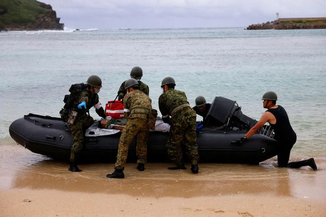 Japan Self-Defense Forces soldiers take part in an evacuation drill on Yonaguni island, Japan's westernmost inhabited island in Okinawa prefecture, Japan November 12, 2023. REUTERS/Issei Kato