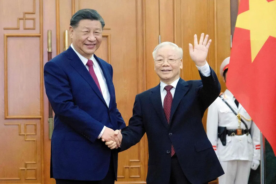 Chinese President Xi Jinping (left) and Vietnamese Communist Party General Secretary Nguyen Phu Trong (R) pose at the Central Office of the Communist Party of Vietnam in Hanoi on December 12, 2023. (Photo by MINH HOANG / POOL / AFP)