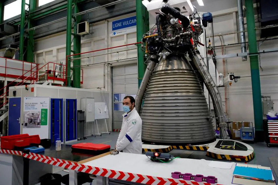 FILE PHOTO: A worker of Ariane Group stands in front of a Ariane 6 rocket's Vulcain 2.1 engine, prior to the visit of French President Emmanuel Macron, in Vernon, France January 12, 2021. Christophe Ena/Pool via REUTERS/File Photo