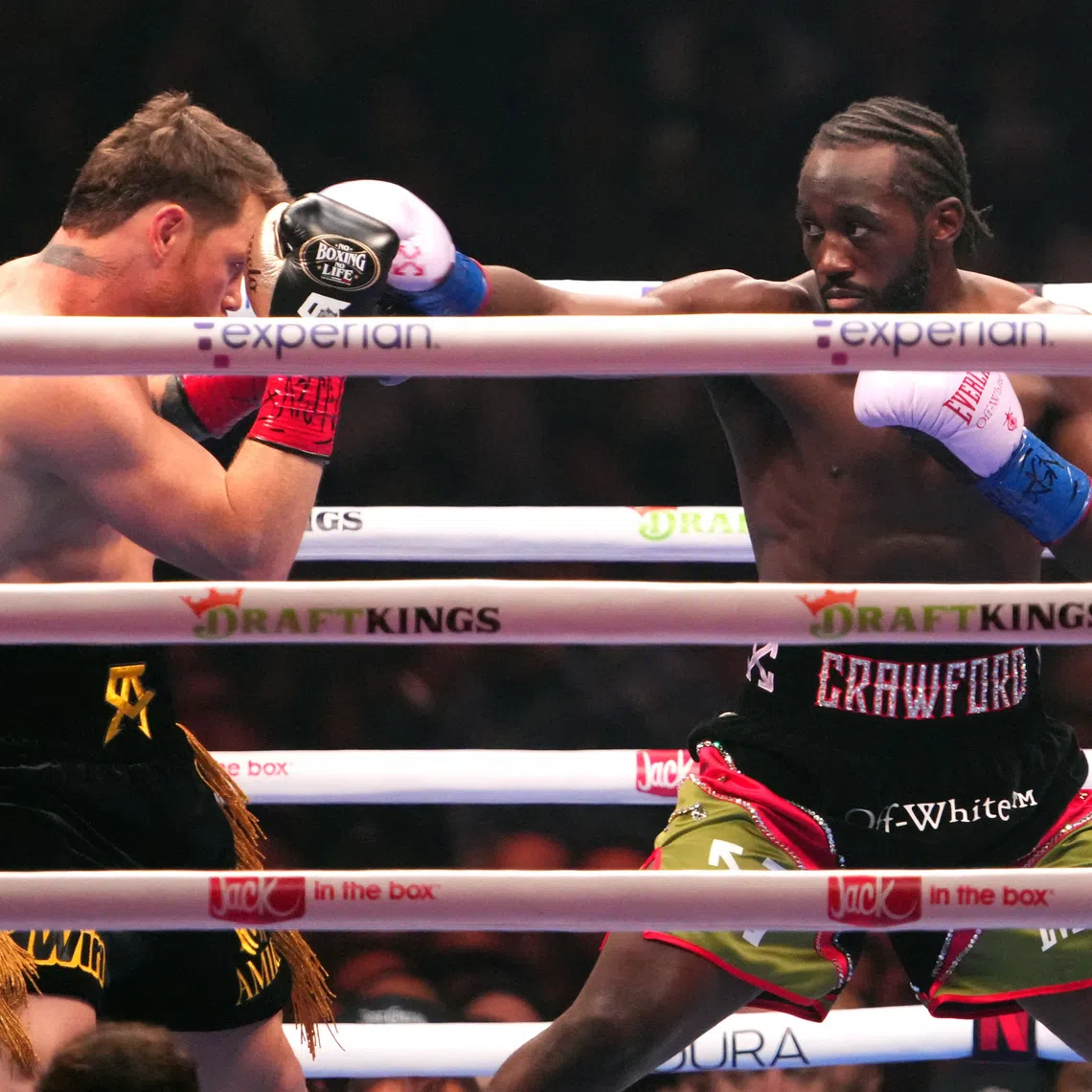 Sep 13, 2025; Las Vegas, Nevada, USA; Canelo Alvarez (black/gold trunks) and Terence Crawford (black/red trunks) box during their super middleweight title bout  at Allegiant Stadium. Mandatory Credit: Joe Camporeale-Imagn Images