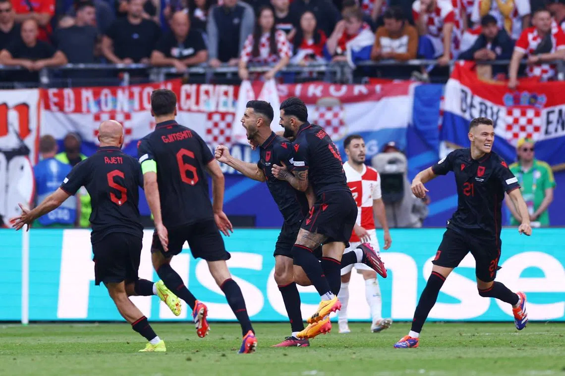 Soccer Football - Euro 2024 - Group B - Croatia v Albania - Hamburg Volksparkstadion, Hamburg, Germany - June 19, 2024 Albania's Klaus Gjasula celebrates scoring their second goal with teammates REUTERS/Lisi Niesner