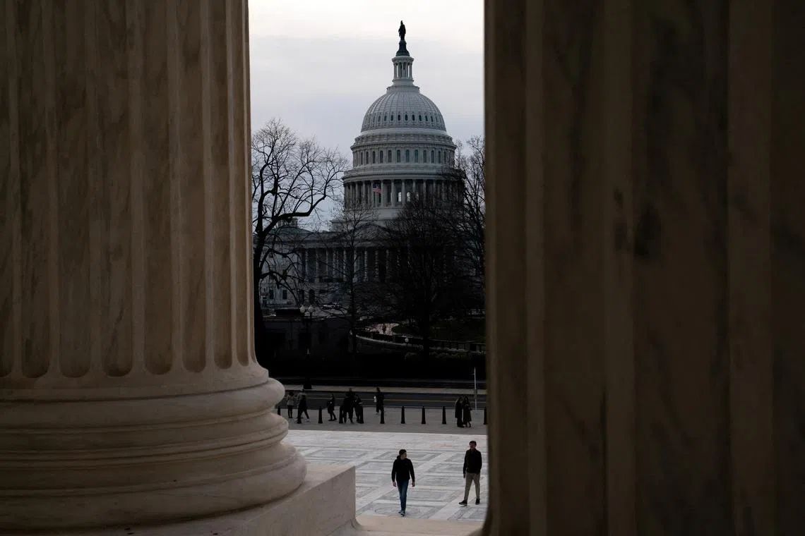 FILE PHOTO: Tourists walk near the U.S. Capitol in Washington, U.S., February 9, 2024. REUTERS/Nathan Howard/File Photo