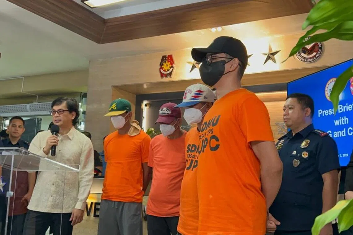 Philippine Interior Secretary Benhur Abalos presents four suspected members of a kidnap-for-ransom gang targeting tourists. 