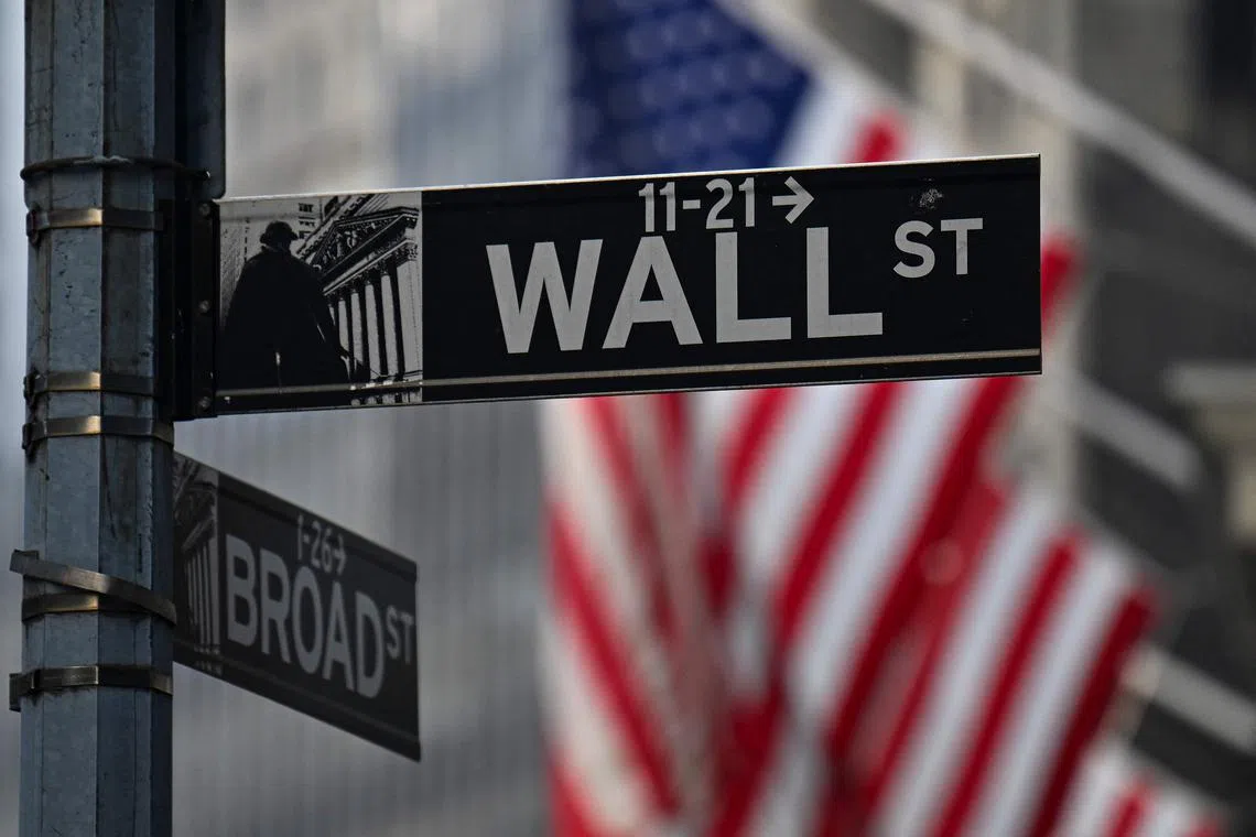 Street signs hang outside the New York Stock Exchange (NYSE) at Wall Street in New York on February 3, 2025. (Photo by ANGELA WEISS / AFP)