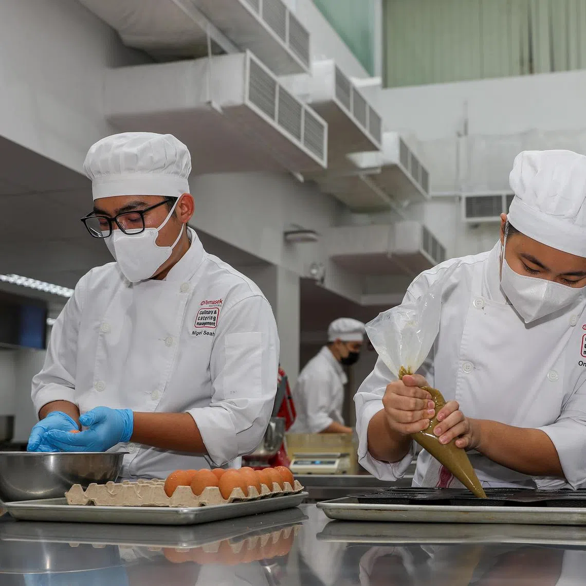 dltca - ST20250717_202523000286. Luther Lau. Pix of Ong Yi Fen,23 (Right) and Nigel Seah,19 (Left) who are year 3 students at Temasek Culinary Academy (TCA) in the baking and pastry kitchen.
ST PHOTO: LUTHER LAU