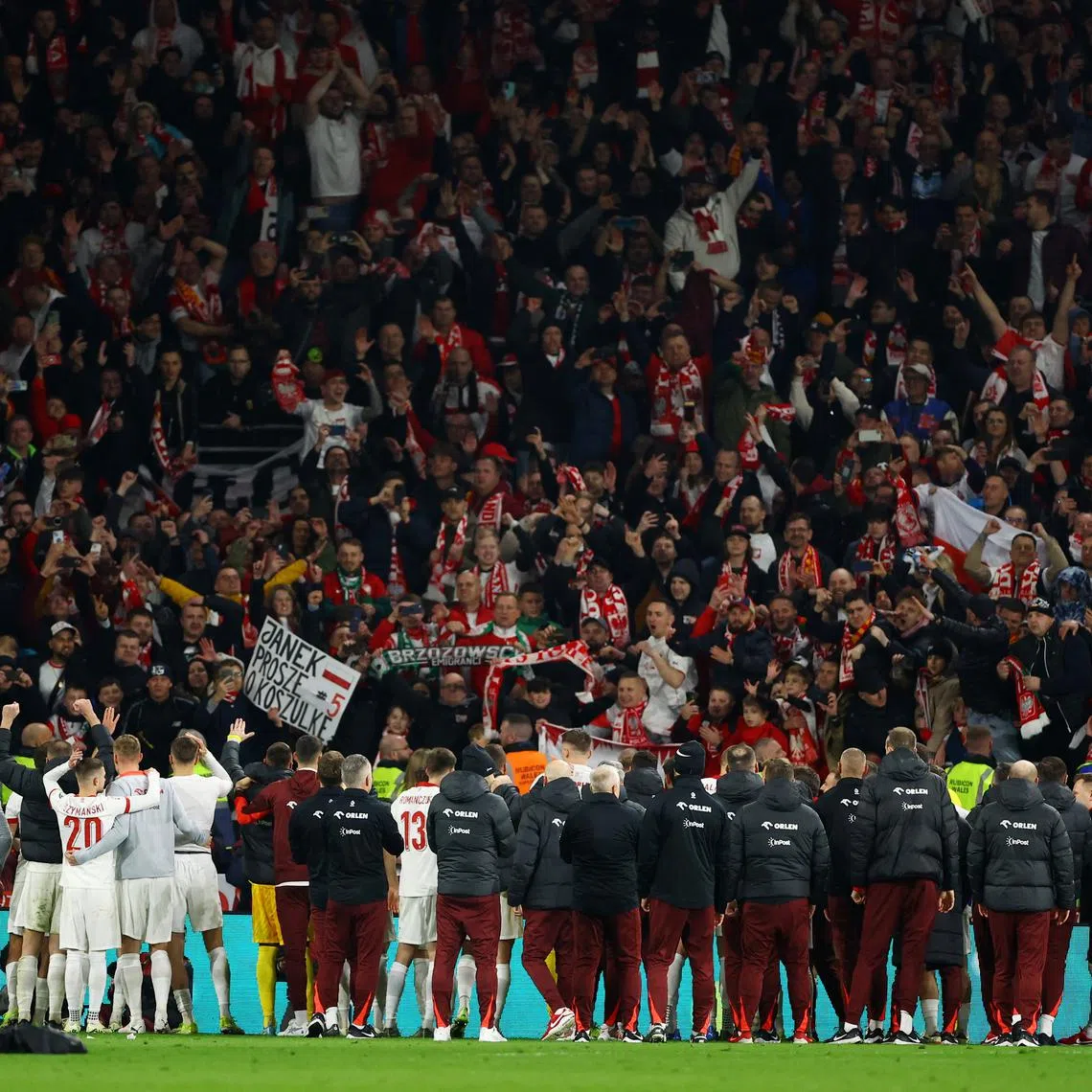 Soccer Football - Euro 2024 Qualifier - Play-Off - Wales v Poland - Cardiff City Stadium, Cardiff, Wales, Britain - March 26, 2024 Poland players and fans celebrate after winning the penalty shootout and qualifying for Euro 2024 REUTERS/Molly Darlington