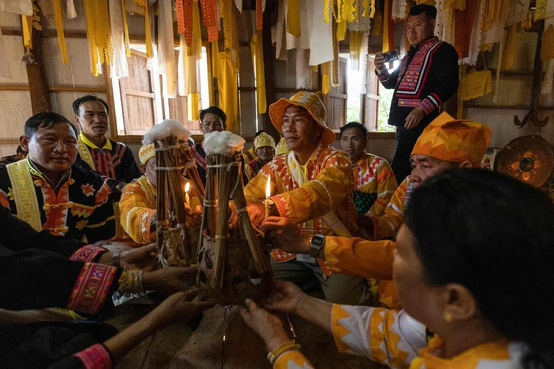 Lahu men taking part in a traditional religious cleansing ceremony in the village of Mae Haeng in Chiang Mai's Mae Ai district on Dec 10, 2025.