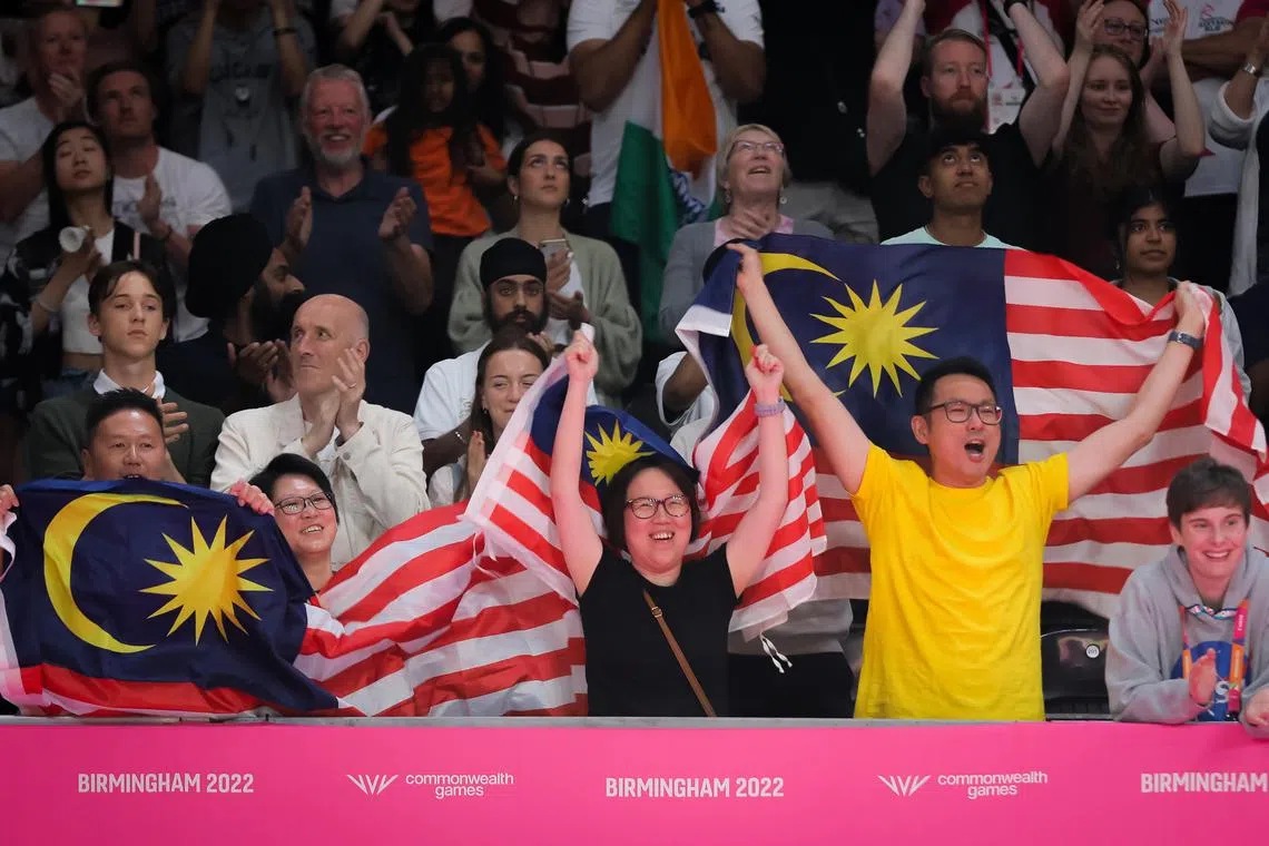 Malaysia fans cheering on their badminton team at the Commonwealth Games in Birmingham in 2022.