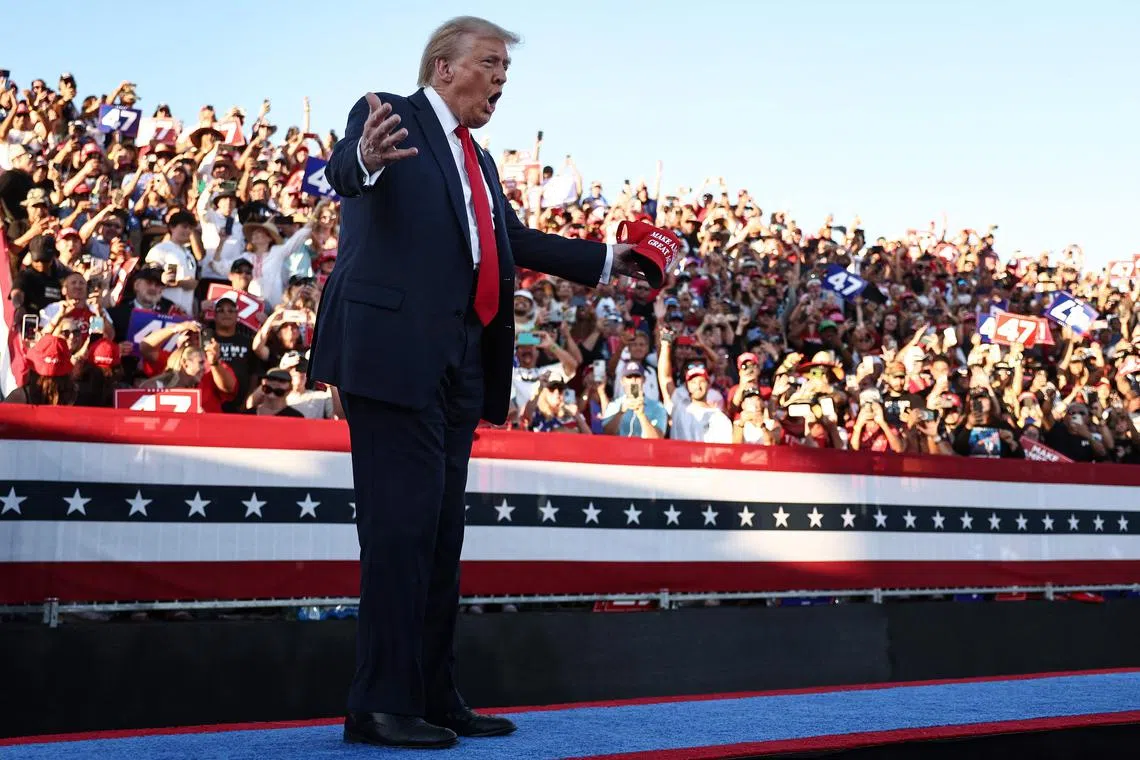 COACHELLA, CALIFORNIA - OCTOBER 12: Republican presidential nominee, former U.S. President Donald Trump gestures as he walks onstage for a campaign rally on October 12, 2024 in Coachella, California. With 24 days to go until election day, former President Donald Trump is detouring from swing states to hold the rally in Democratic presidential nominee, Vice President Kamala Harris' home state.   Mario Tama/Getty Images/AFP (Photo by MARIO TAMA / GETTY IMAGES NORTH AMERICA / Getty Images via AFP)