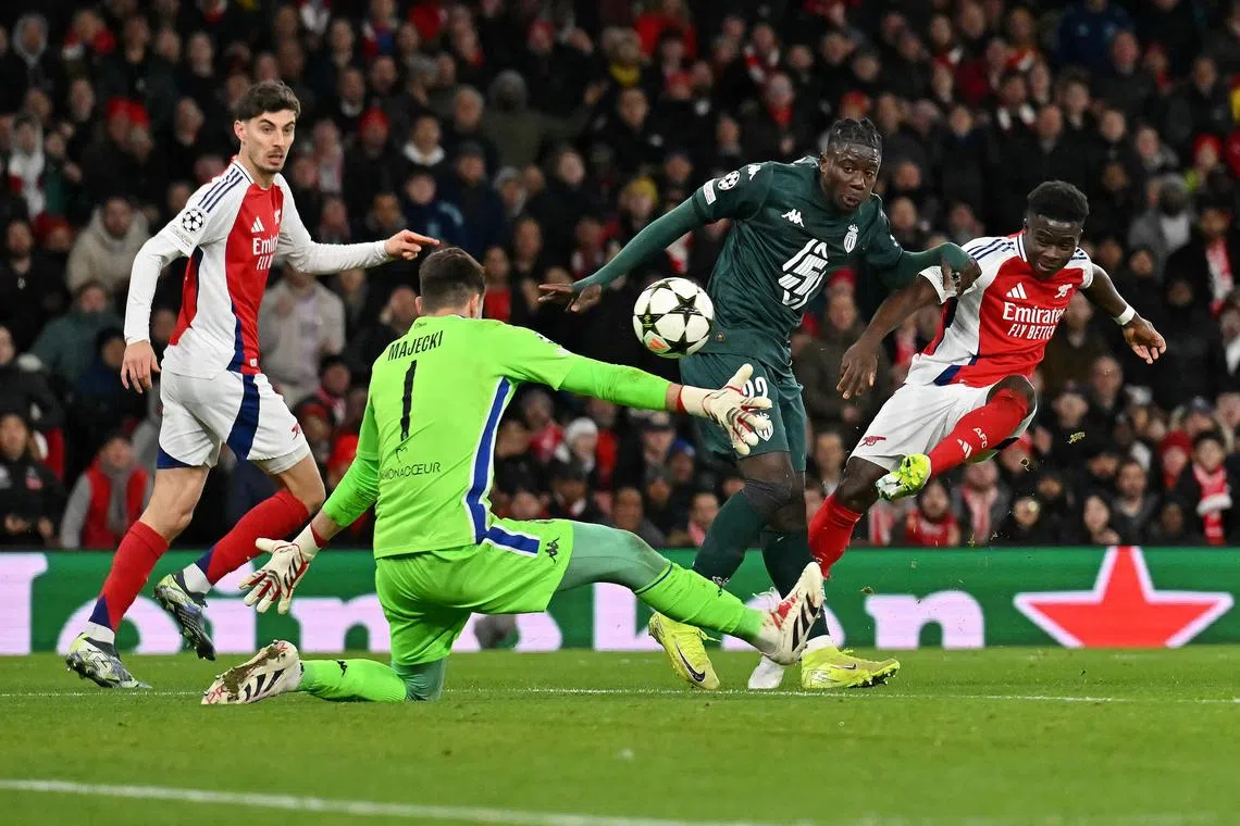 Bukayo Saka scores his and Arsenal's second goal in the 3-0 Champions League win over Monaco.