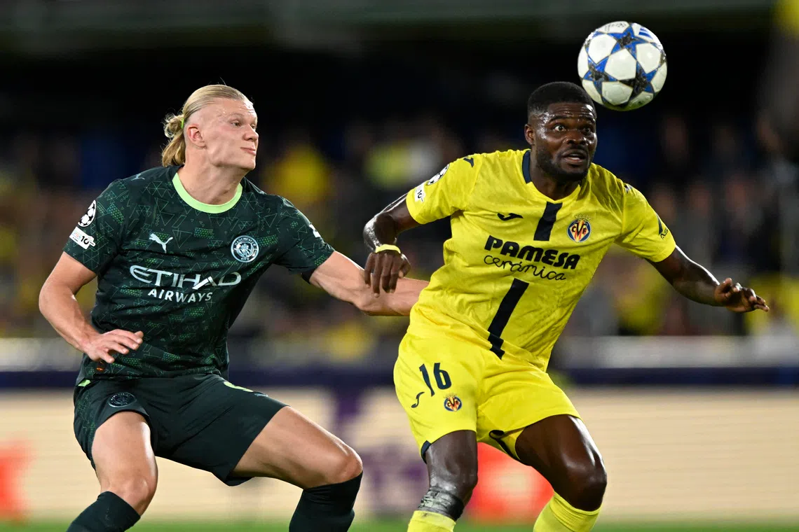 Soccer Football - UEFA Champions League - Villarreal v Manchester City - Estadio de la Ceramica, Villarreal, Spain - October 21, 2025 Villarreal's Thomas Partey in action with Manchester City's Erling Haaland REUTERS/Pablo Morano