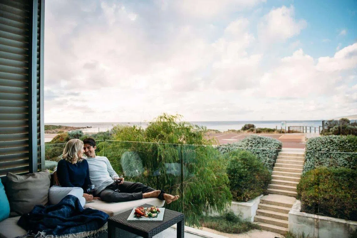 Couple lounging on day bed at Smiths Beach Resort, Western Australia