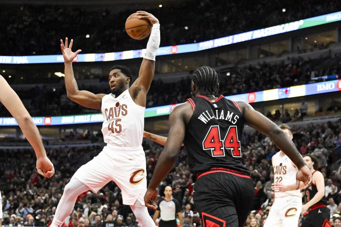 FILE PHOTO: Nov 11, 2024; Chicago, Illinois, USA;  Cleveland Cavaliers guard Donovan Mitchell (45) grabs a rebound away from Chicago Bulls forward Patrick Williams (44) during the second half at United Center. Mandatory Credit: Matt Marton-Imagn Images/File Photo