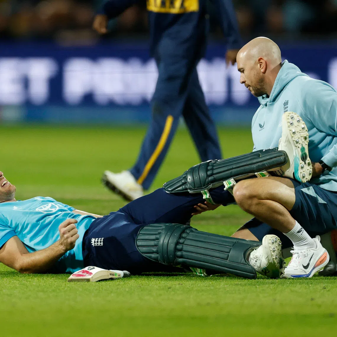 Cricket - Second One Day International - England v Sri Lanka - Headingley Cricket Ground, Leeds, Britain - September 24, 2026 England's Jos Buttler receives medical attention after sustaining an injury Action Images via Reuters/Jason Cairnduff