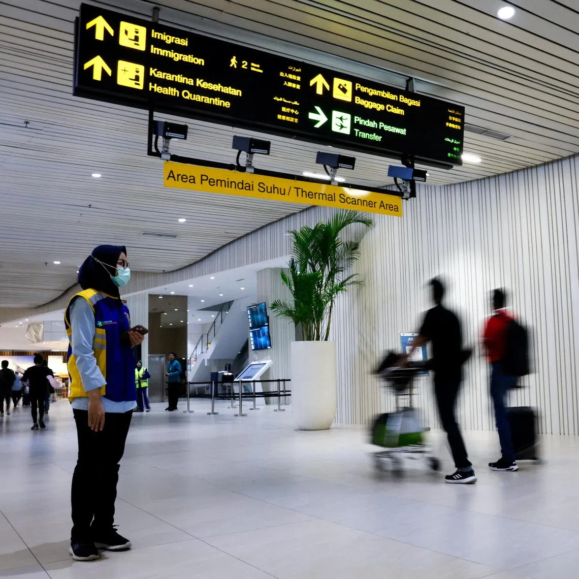 Travellers walking past a thermal scanner area at Jakarta's Soekarno Hatta International Airport on Jan 30.