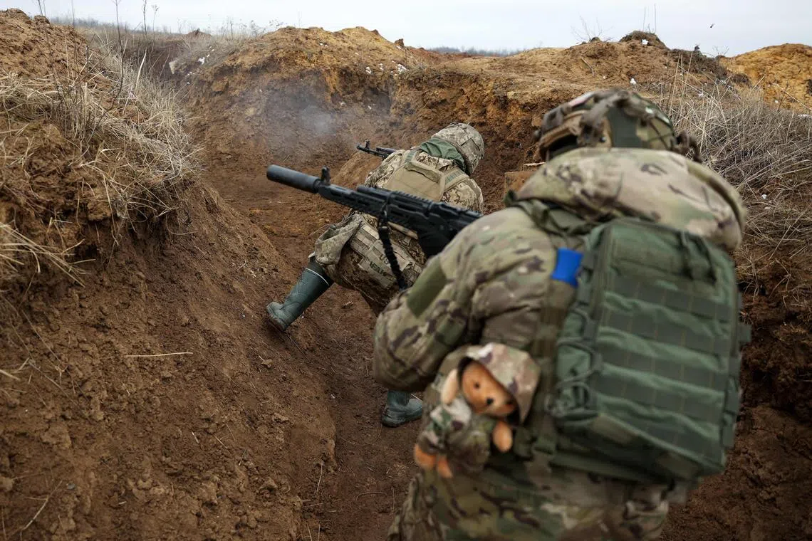 Ukrainian servicemen go through military training near the front line, in Ukraine's Donetsk region. 