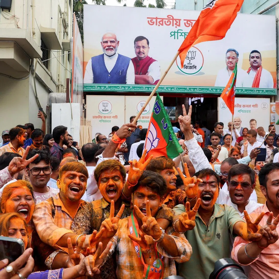 India’s ruling BJP supporters celebrate as early trends show their party leading in the West Bengal state assembly election results, outside the party's regional office in Kolkata, India, May 4.