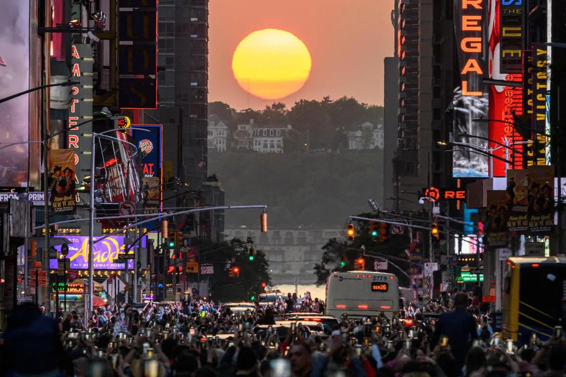 The Sun sets in alignment with Manhattan streets running east-west, also known as Manhattanhenge, in New York City on May 30, 2023. Manhattanhenge occurs about the same two days in May and then again on two days in July every year. 