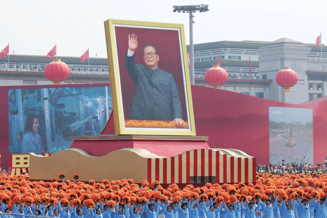 Performers travel past Tiananmen Square next to a float showing former Chinese president Jiang Zemin during the parade marking the 70th founding anniversary of People's Republic of China, on its National Day in Beijing, China on Oct 1, 2019.  