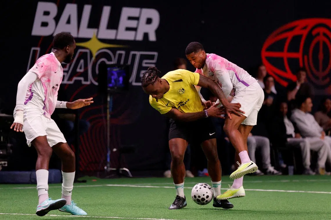 FILE PHOTO: Soccer Football - Baller League - Matchday 8 - MVPs United v NDL FC - Copper Box Arena, London, Britain - December 15, 2025 NDL FC's Razzaq Coleman in action with MVPs United's Montel McKenzie Action Images via Reuters/Andrew Couldridge/File Photo