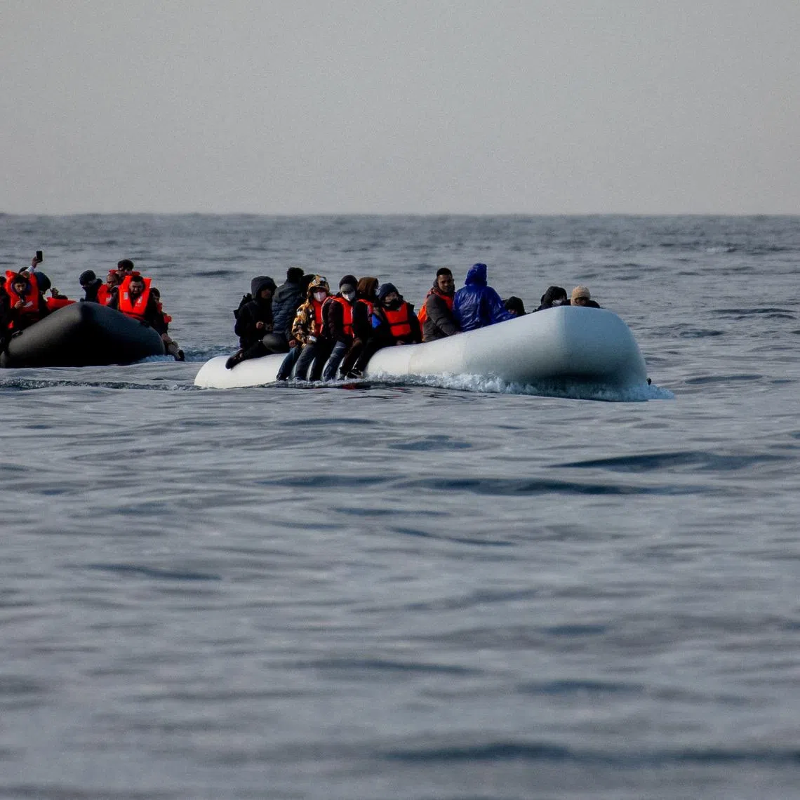 Two inflatable dinghies carrying migrants make their way towards England in the English Channel, Britain, May 4, 2024. REUTERS/Chris J. Ratcliffe