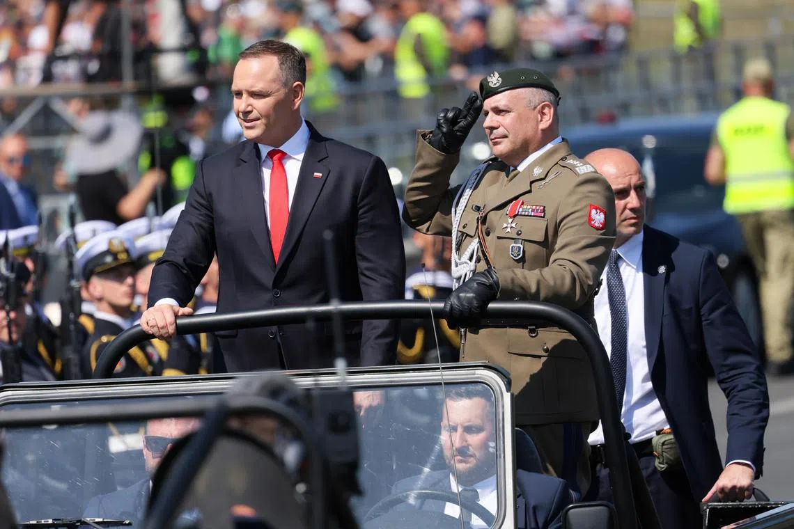 Polish President Karol Nawrocki (left) and the Polish army's Chief of General Staff Wieslaw Kukula taking part in the Warsaw parade on Aug 15.