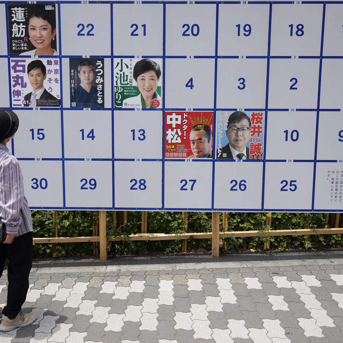 epa11424397 A passerby looks at a board displaying campaign posters of candidates running for the upcoming Tokyo gubernatorial election in Tokyo, Japan, 20 June 2024. The official campaigning for the Tokyo gubernatorial election kicked off on 20 June as incumbent Yuriko Koike is aiming for a third four-year term. Koike has the support of the ruling bloc and is challenged by the main opposition-backed politician Renho. A record 56 people had registered to run for the election that will be held on 07 July 2024 to elect the new governor of Tokyo.  EPA-EFE/FRANCK ROBICHON
