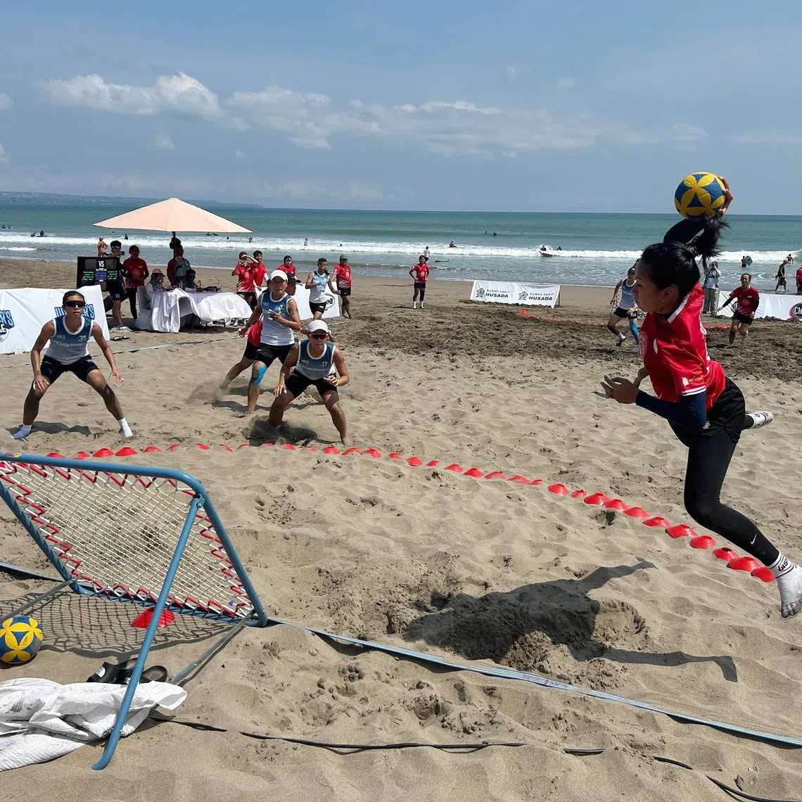 Singapore's Liaw Li Qing (right) launching an attack against Chinese Taipei in the final of the World Beach Tchoukball Championships in Bali.
