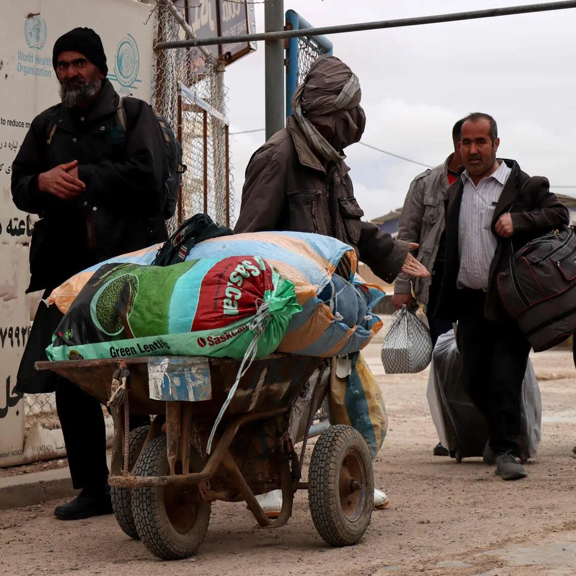 Afghan nationals arrive at the Islam Qala border crossing between Afghanistan and Iran in Herat province on March 10.