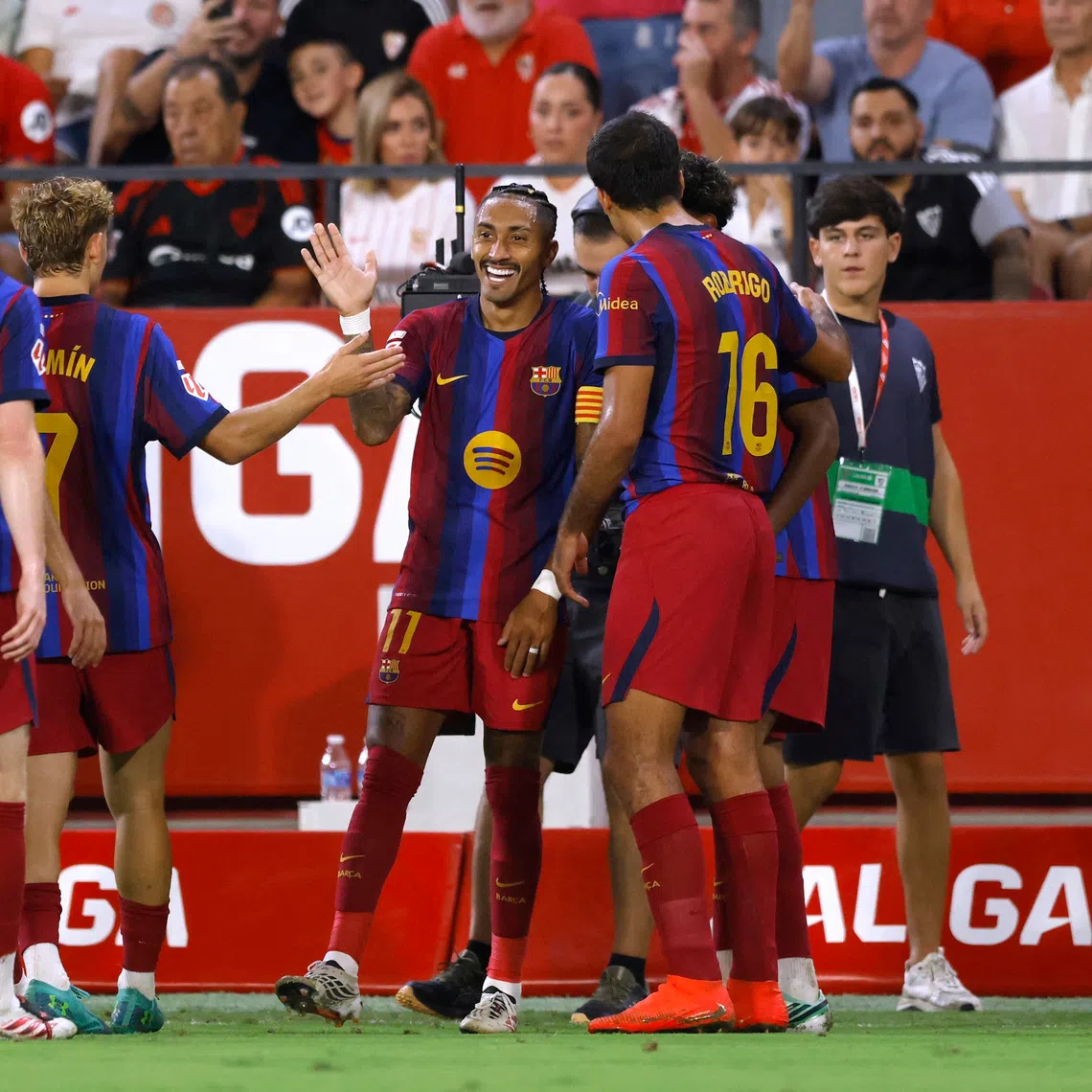 Barcelona captain Raphinha celebrates scoring his third goal with teammates during their 3-1 victory over Sevilla on Sept 19.
