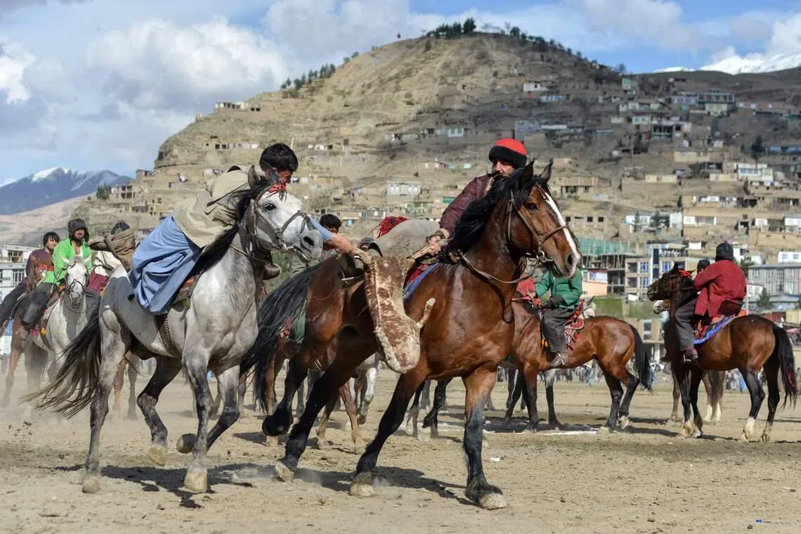 Afghan horse riders competing in buzkashi, a traditional Central Asian goat-grabbing sport, at a field in Faizabad district, Badakhshan province on March 23.