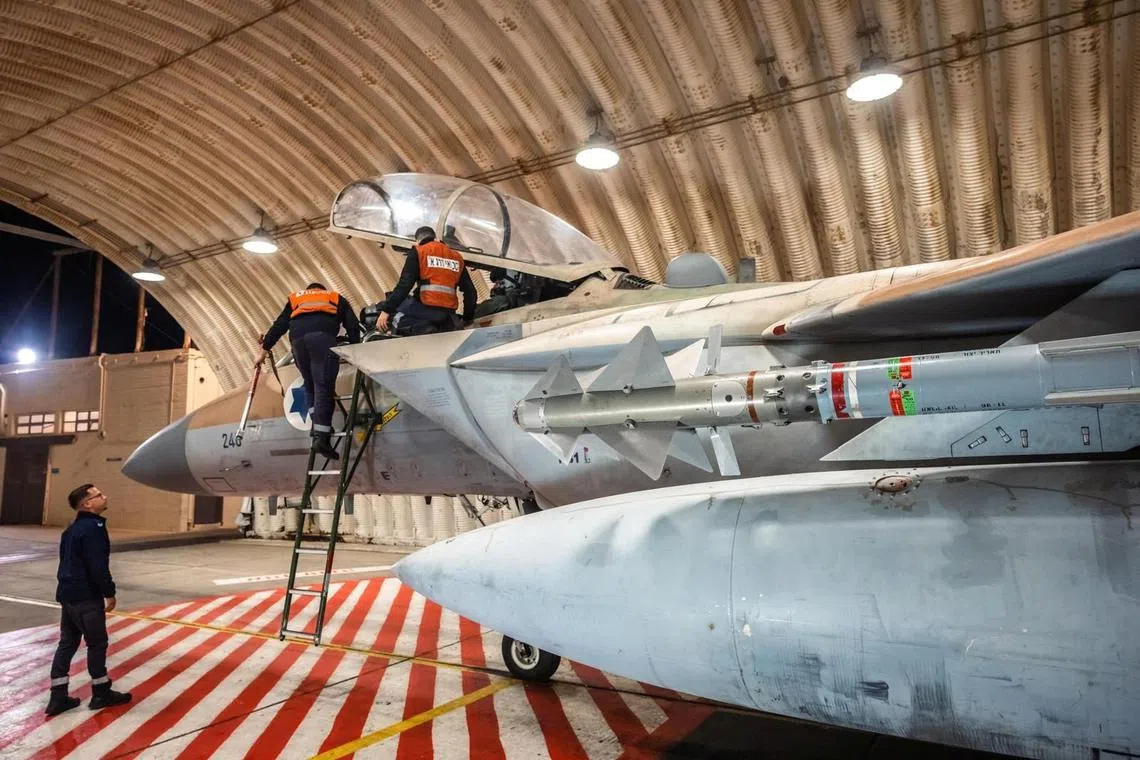 Crews work on an Israeli Air Force F-15 Eagle in a hangar, said to be following an interception mission of an Iranian drone and missile attack on Israel, in this handout image released April 14, 2024. Israel Defense Forces/Handout via REUTERS
