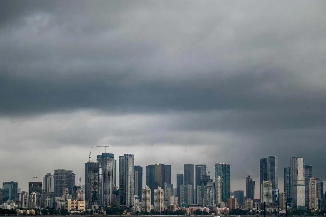 Dark monsoon clouds hover over the city skyline in Mumbai on May 22, 2025. (Photo by Punit PARANJPE / AFP)