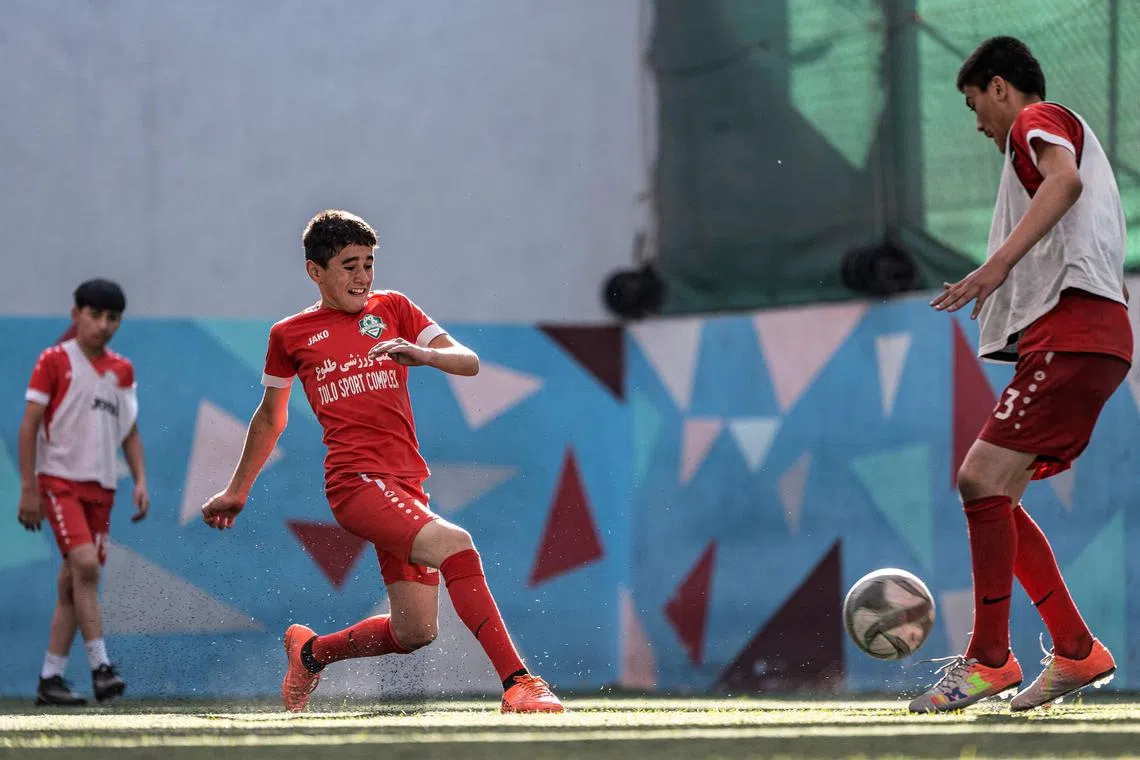 Afghan youths playing futsal at a sports complex in Kabul on Sept 25.