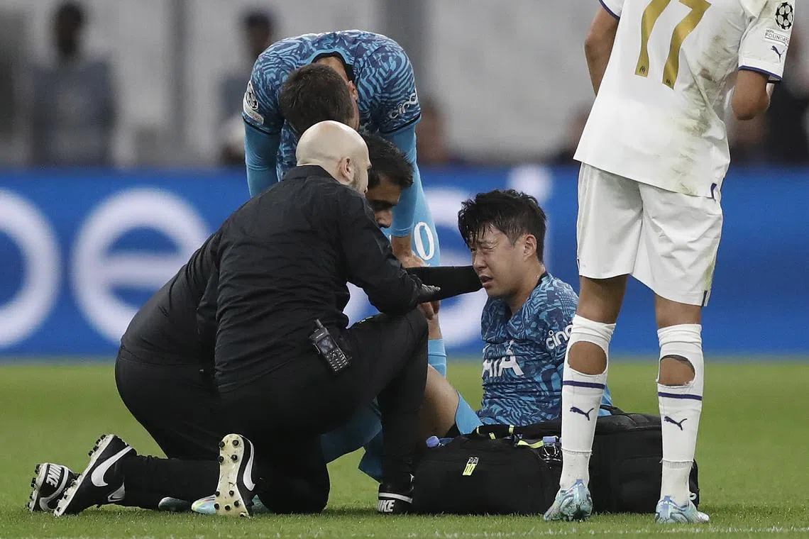 Tottenham's Son Heung-Min Son receives medical assistance during the Champions League match against Olympique Marseille.
