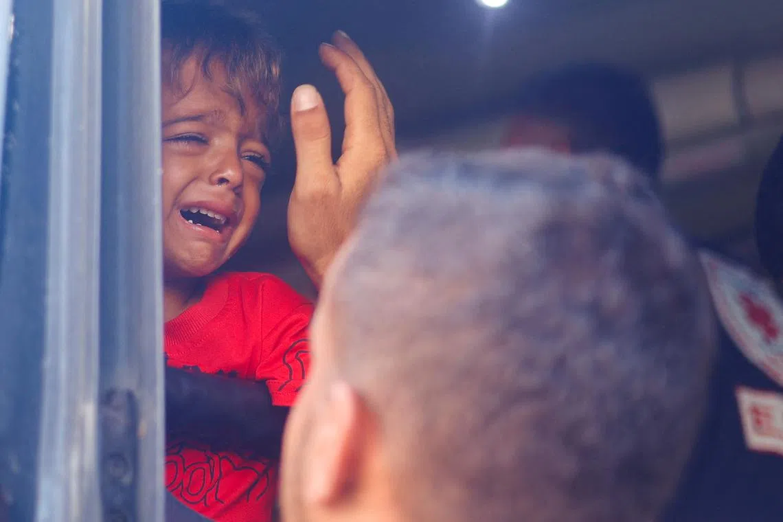 A Palestinian boy, who is a patient, cries as his father bids him farewell before he is transferred for treatment abroad through the Kerem Shalom crossing, amid the Israel-Hamas conflict, in Khan Younis in the southern Gaza Strip June 27, 2024. REUTERS/Mohammed Salem