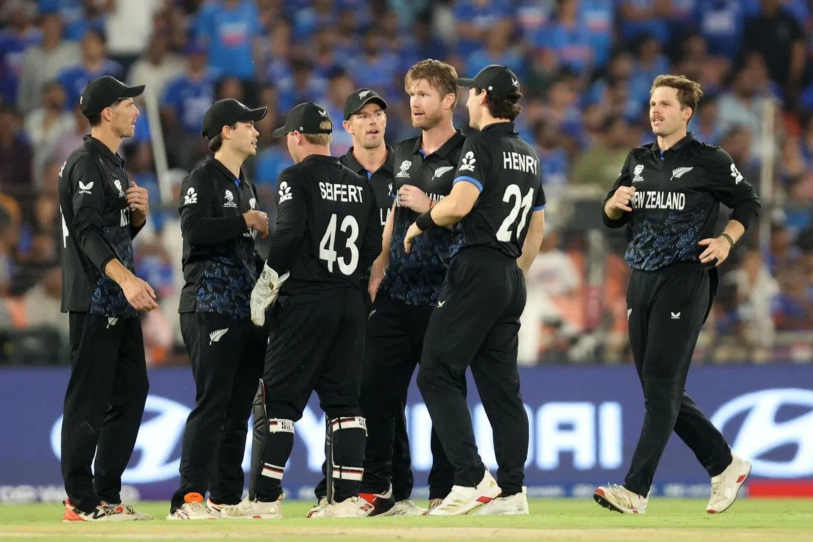 Cricket - ICC Men's T20 World Cup 2026 - Final - India v New Zealand - Narendra Modi Stadium, Ahmedabad, India - March 8, 2026 New Zealand's Jimmy Neesham celebrates with teammates after taking the wicket of India's Ishan Kishan REUTERS/Amit Dave