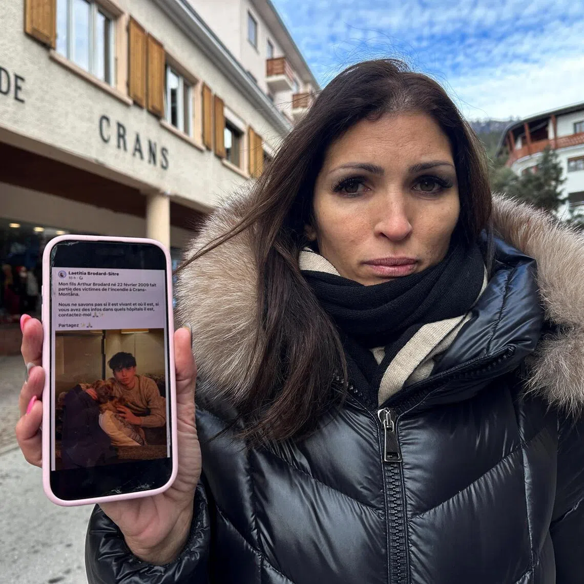 Laetitia Brodard-Sitre holds a phone displaying her social media post about her 16-year-old son Arthur, who went missing after a fire and explosion at the "Le Constellation" bar during a New Year's Eve party where people died and others were injured, in the upscale ski resort of Crans-Montana in southwestern Switzerland, January 2, 2026. Picture taken with an iPhone. REUTERS/Noemie Olive
