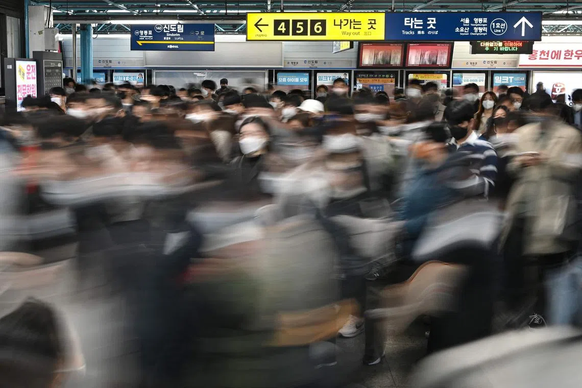 Commuters walking at a subway station in Seoul. South Korea shattered its own record for the world’s lowest fertility rate in 2021.
