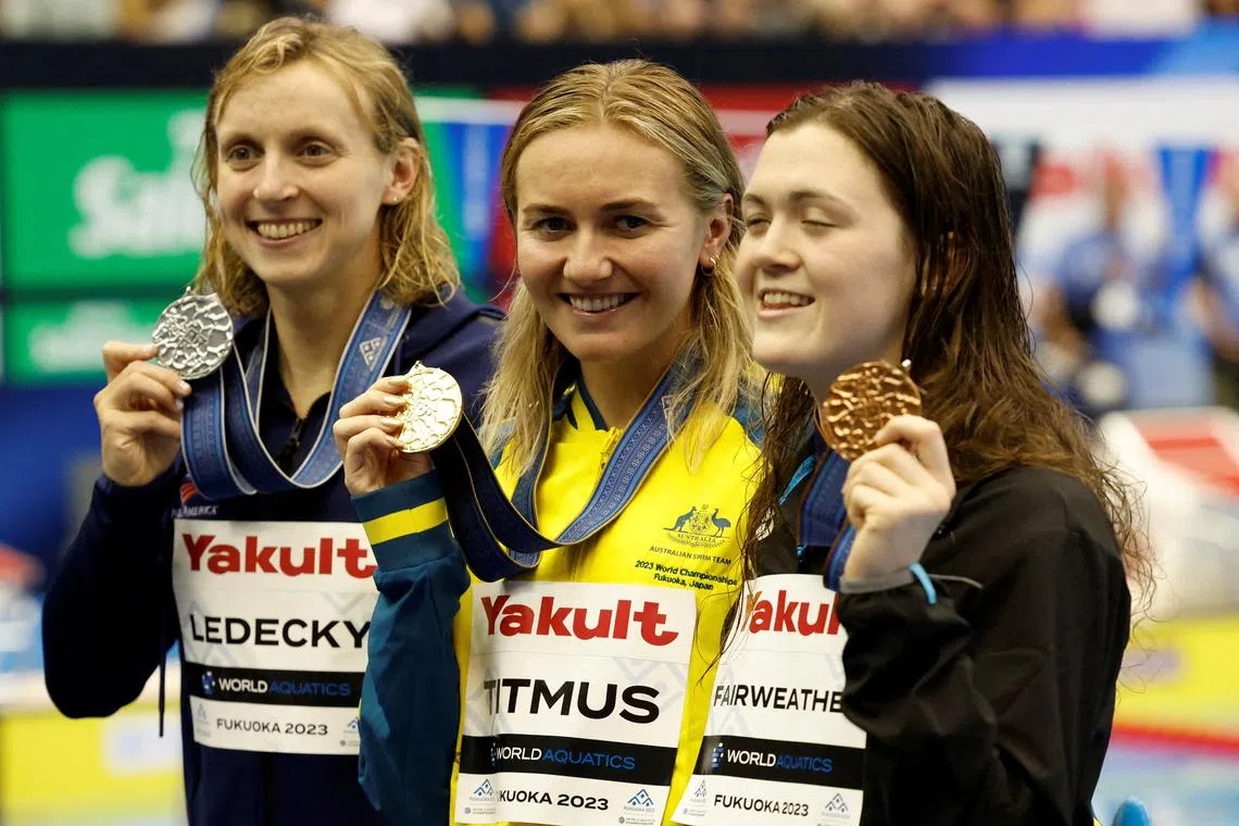 FILE PHOTO: FILE PHOTO: Fukuoka 2023 World Aquatics Championships - Swimming - Marine Messe Fukuoka Hall A, Fukuoka, Japan - July 23, 2023  Australia's Ariarne Titmus celebrates on the podium after winning the women's 400m freestyle final alongside silver medallist Katie Ledecky of the U.S. and bronze medallist New Zealand's Erika Fairweather REUTERS/Issei Kato/File Photo
