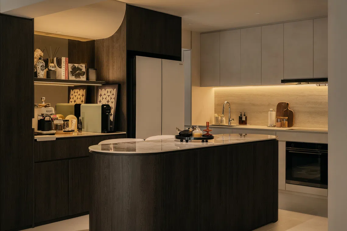 A curved island and dedicated coffee pantry support the couple’s daily routines.