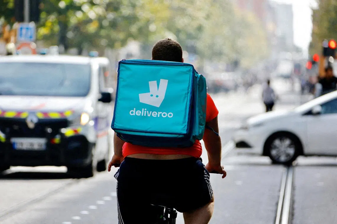 FILE PHOTO: A delivery worker with a backpack of Deliveroo rides a bike in Nice, France, October 25, 2022.  REUTERS/Eric Gaillard//File Photo
