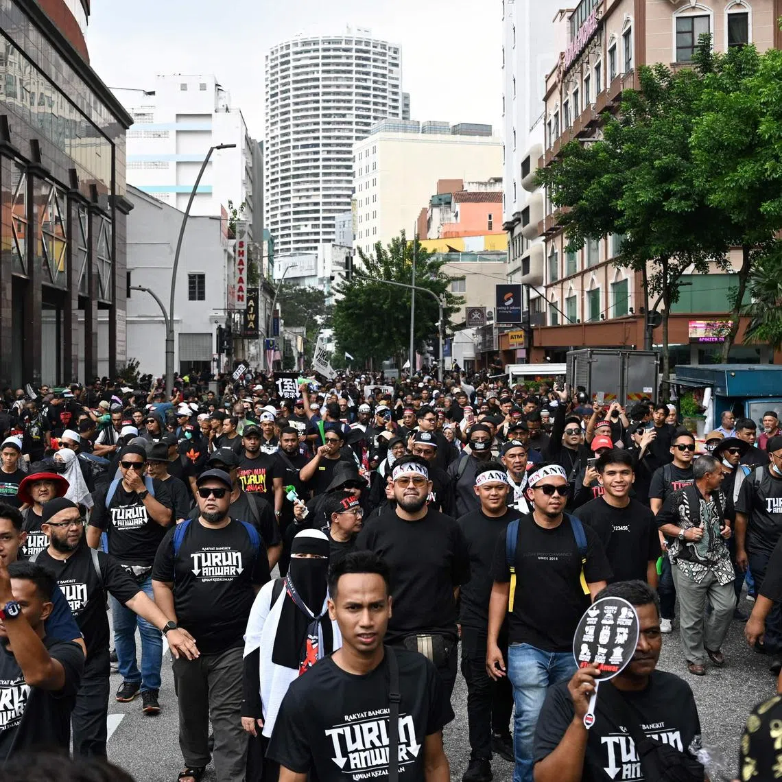 Protesters marching towards Merdeka Square during a protest against Prime Minister Anwar Ibrahim in Kuala Lumpur on July 26.