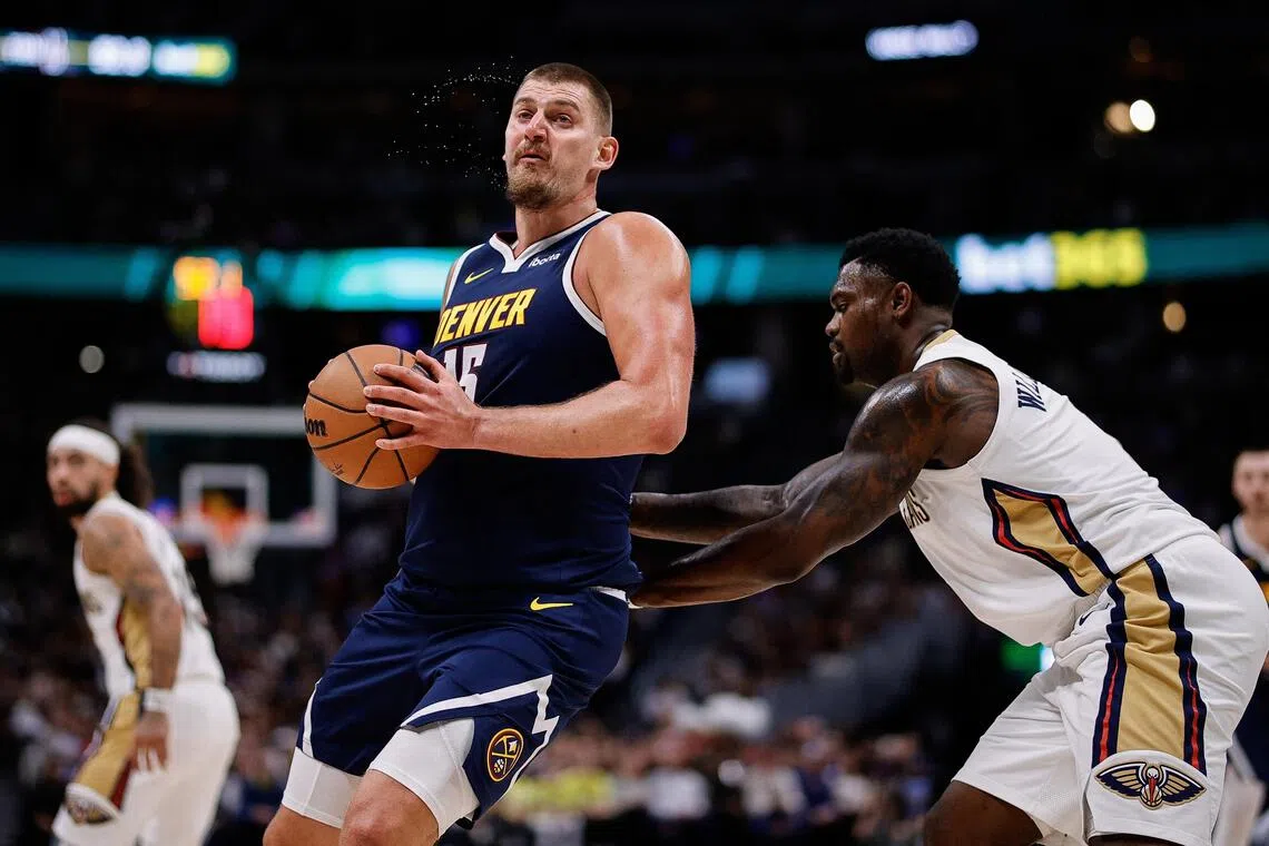 Denver Nuggets centre Nikola Jokic controlling the ball under pressure form New Orleans Pelicans forward Zion Williamson in the third quarter of Denver's 122-88 NBA win at Ball Arena on Oct 29, 2025.
