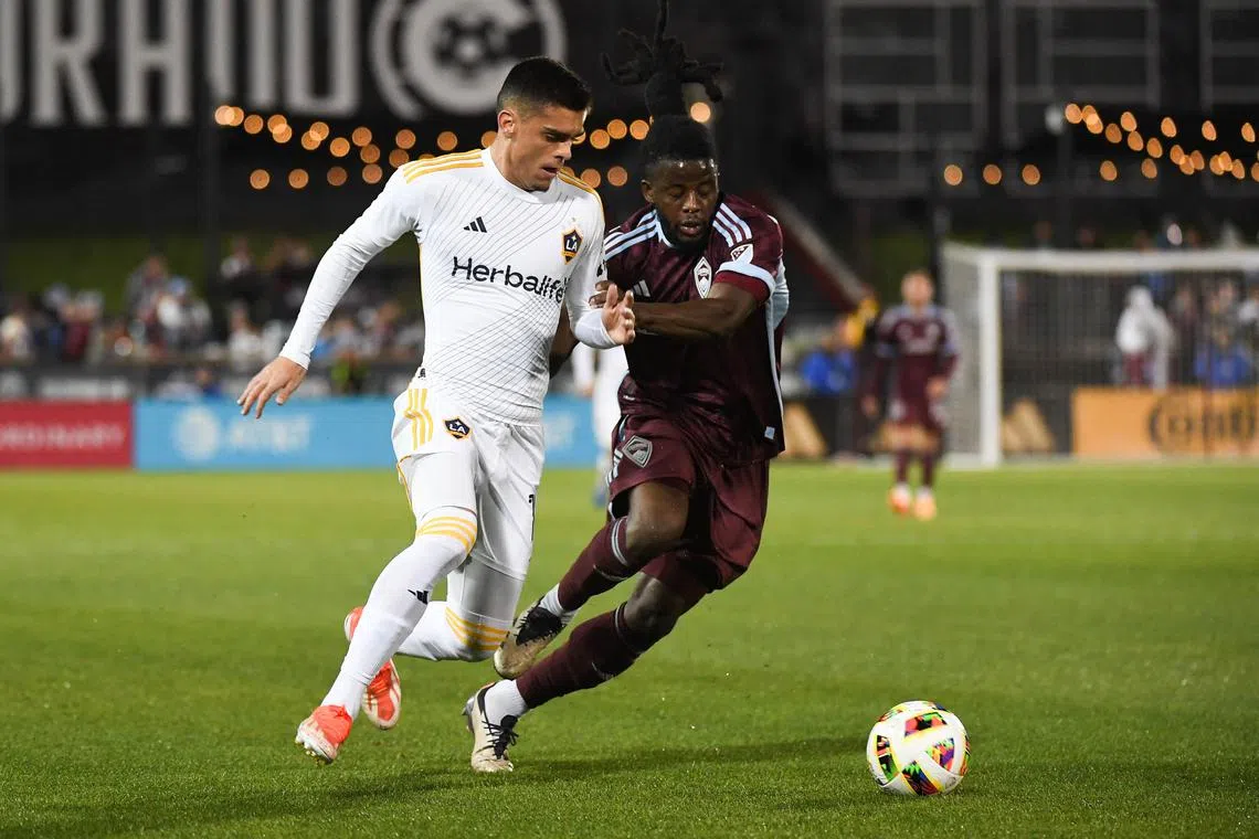 Nov 1, 2024; Commerce City, Colorado, USA; LA Galaxy forward Gabriel Pec (11) battles for the ball against Colorado Rapids defender Lalas Abubakar (6) during the first half in a 2024 MLS Cup Playoffs Round One match at Dick's Sporting Goods Park. Mandatory Credit: Christopher Hanewinckel-Imagn Images/ File Photo